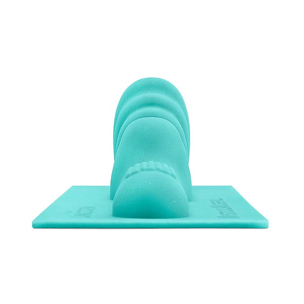 A teal textured attachment with cascading waves on a flat base.