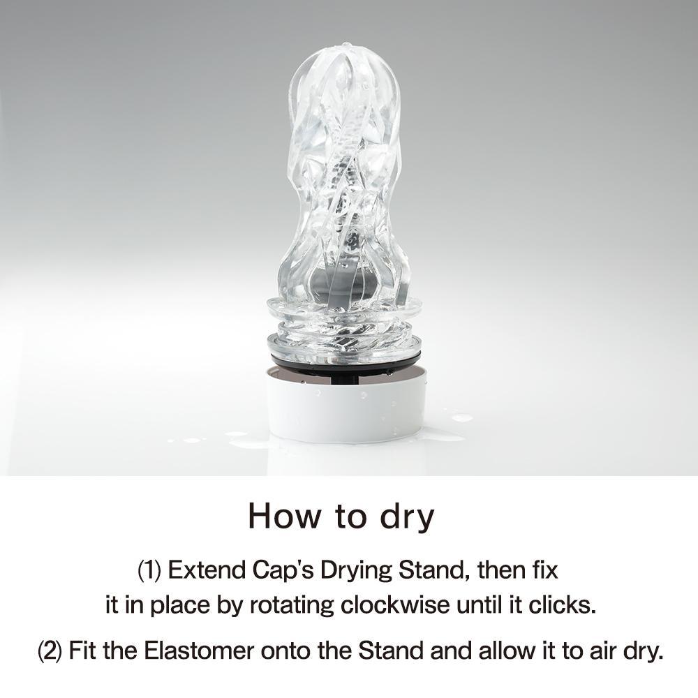 A clear male masturbator with a white base and instructions on how to dry it.
