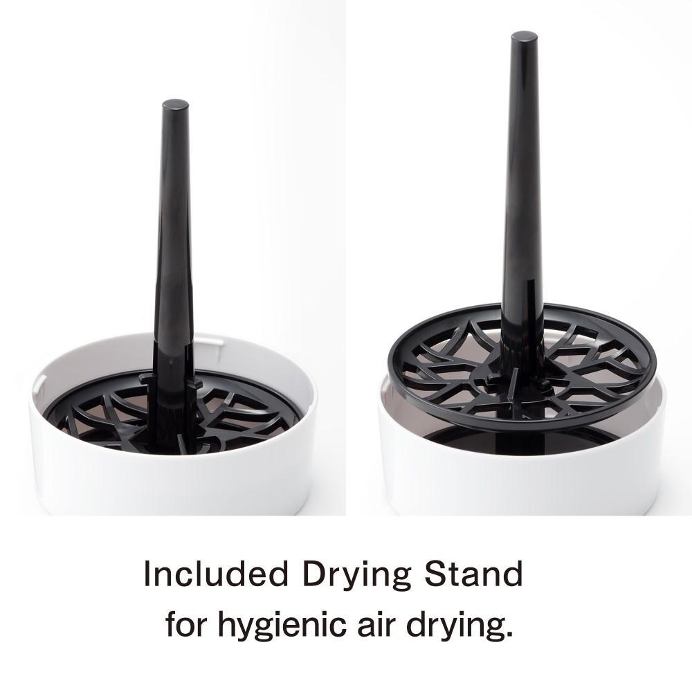 A white drying stand with a black central rod and a black patterned base.