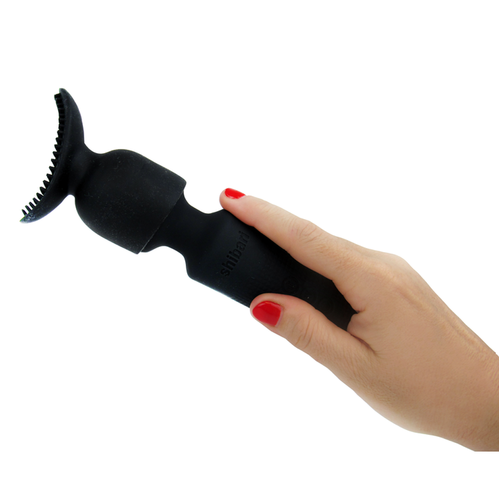 Black silicone texture attachment with teeth on a hand.