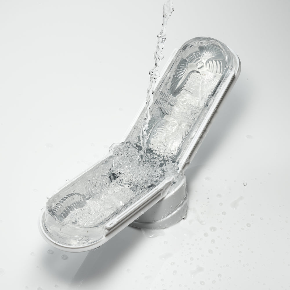 Tenga Flip Zero male masturbator with white TPE sleeve being rinsed with water.