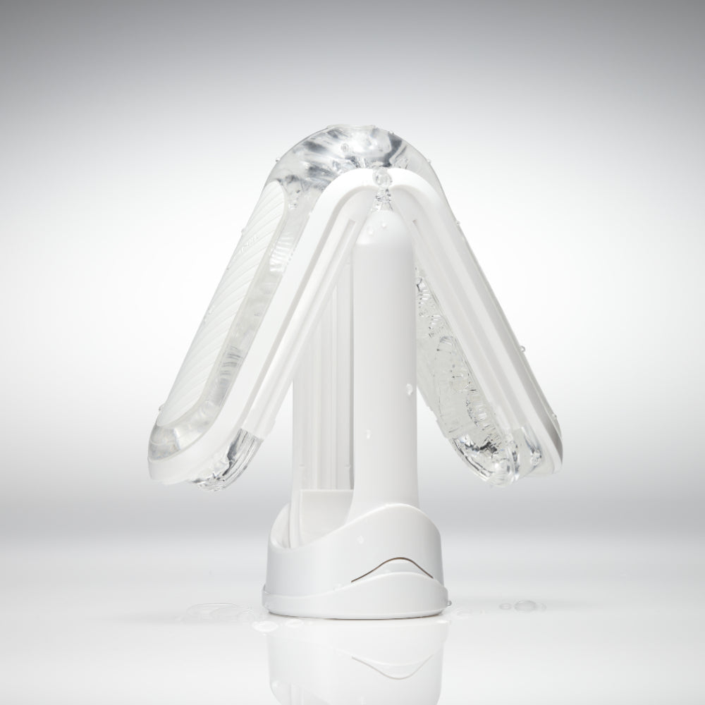 White Tenga Flip Zero masturbator with a clear TPE sleeve and water droplets.