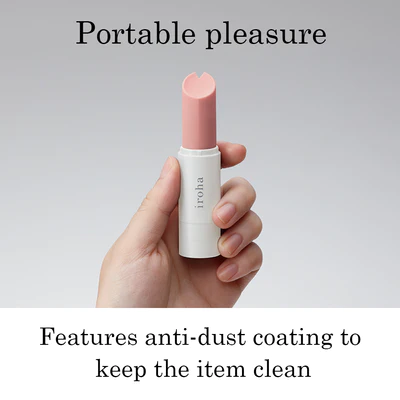 A hand holds a light pink Iroha Stick personal massager.