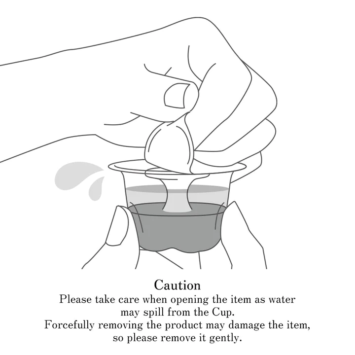 Illustration of hands opening a small cup with liquid, with caution text below.