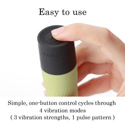 A hand presses the button on a green and black vibrator with the word "iroha" on it.