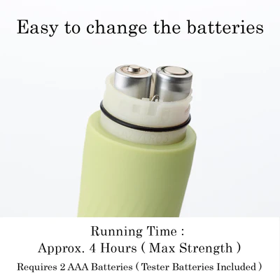 A light green vibrator with two AAA batteries visible inside.