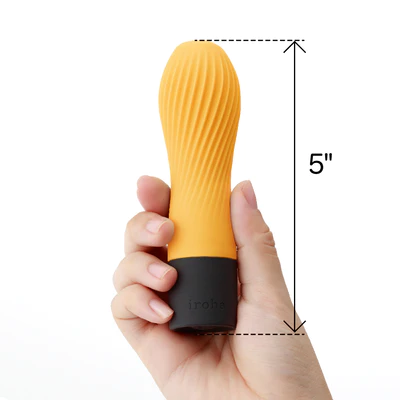 A hand holds a 5-inch orange silicone vibrator with a black base.