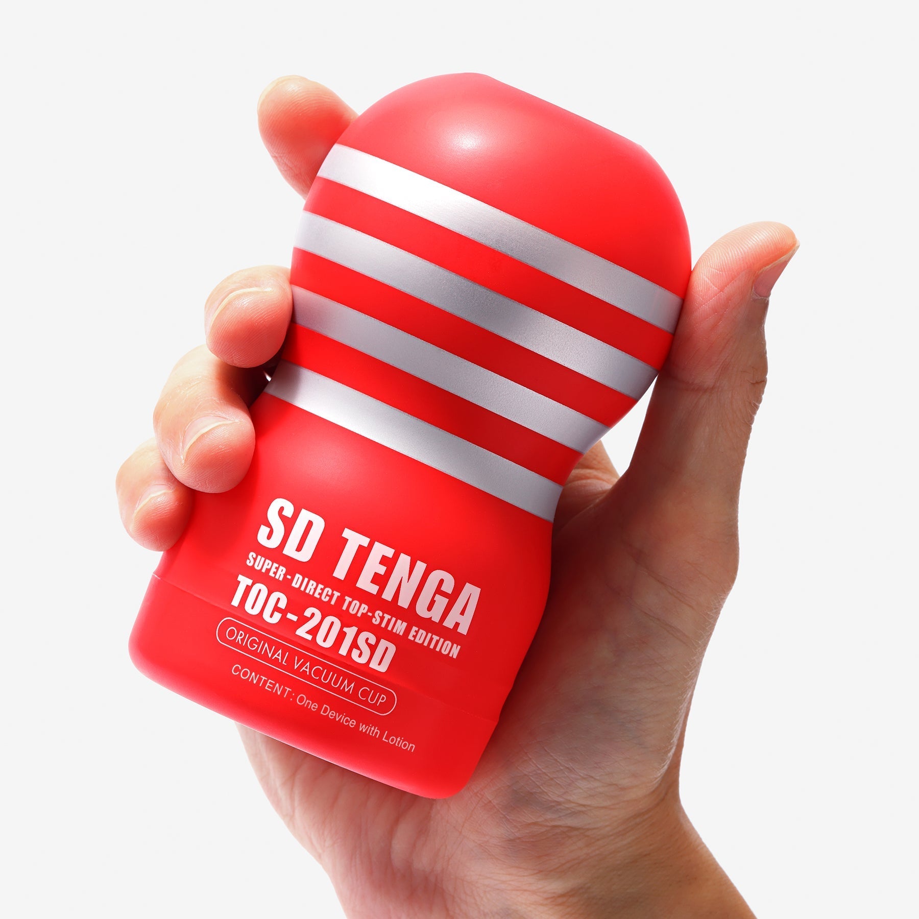 A red and silver striped Tenga vacuum cup held in a hand.