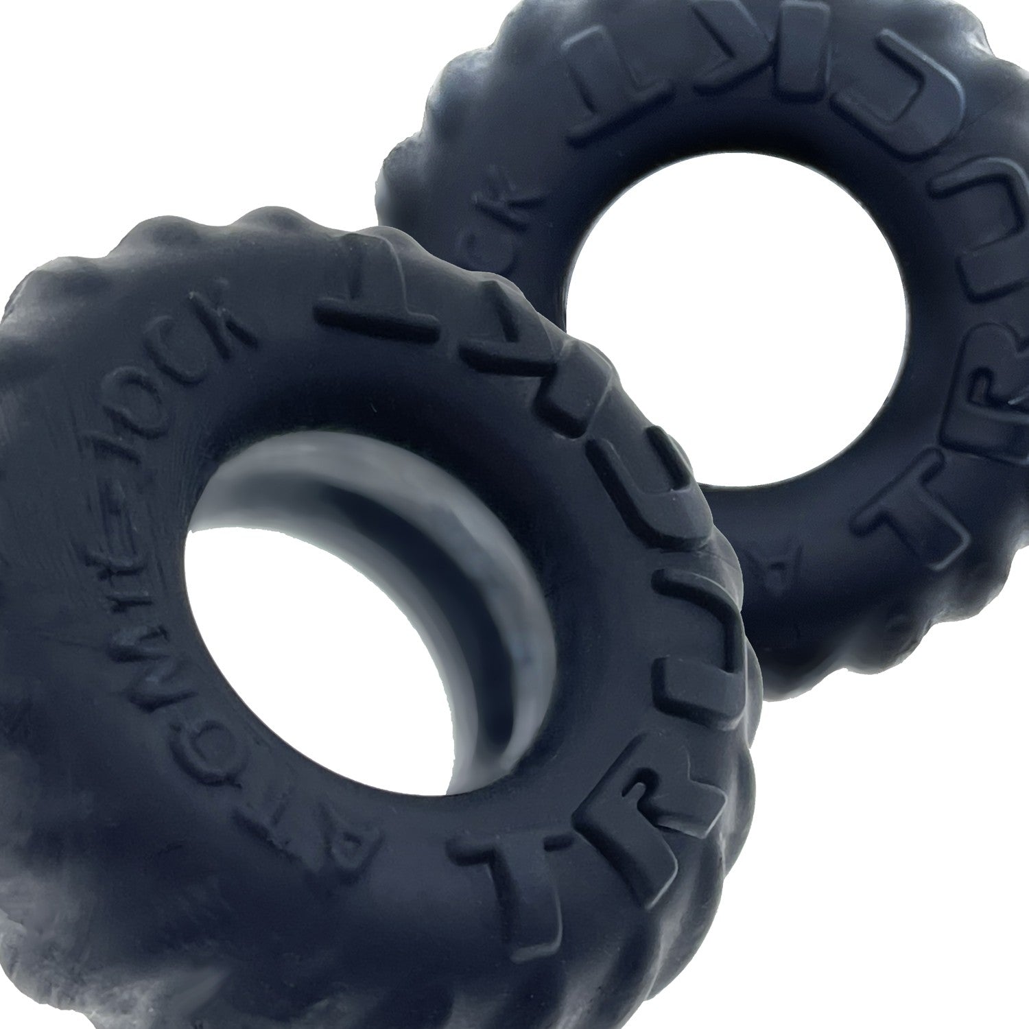 Two dark grey silicone cock rings with tire tread texture.