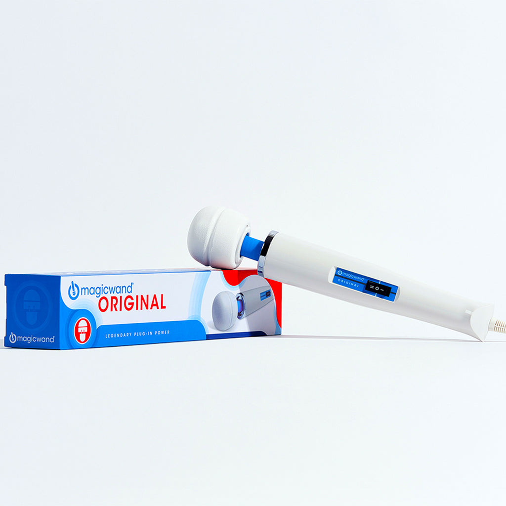 A white Magic Wand Original massager rests on its blue and white box.