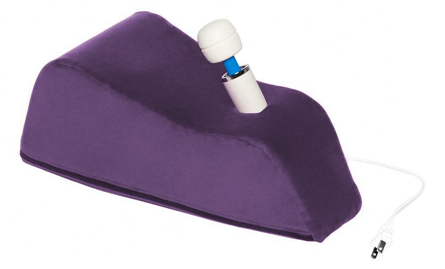 Purple wedge pillow with a white wand massager inserted.