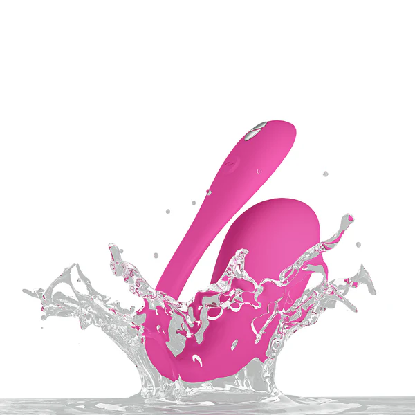 Electric pink Jive 2 vibrator splashing in water.