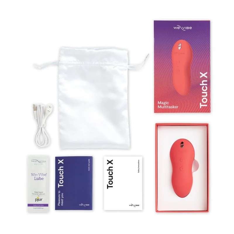 A coral-colored vibrating massager with accessories and packaging.