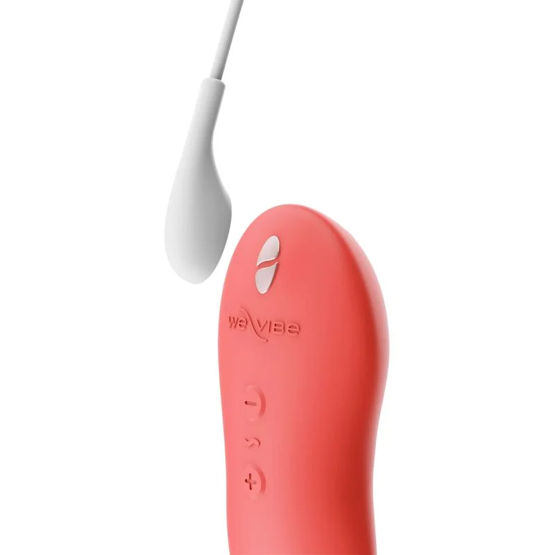 A coral We-Vibe massager with a white attachment and control buttons.
