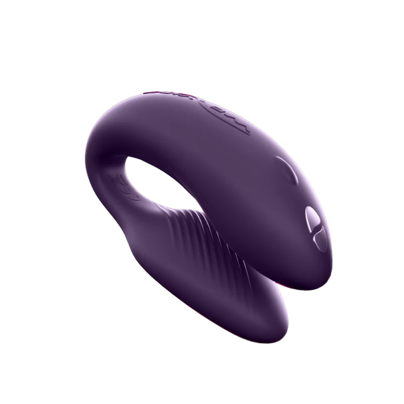 Purple couples vibrator with a curved shape and textured inner surface.
