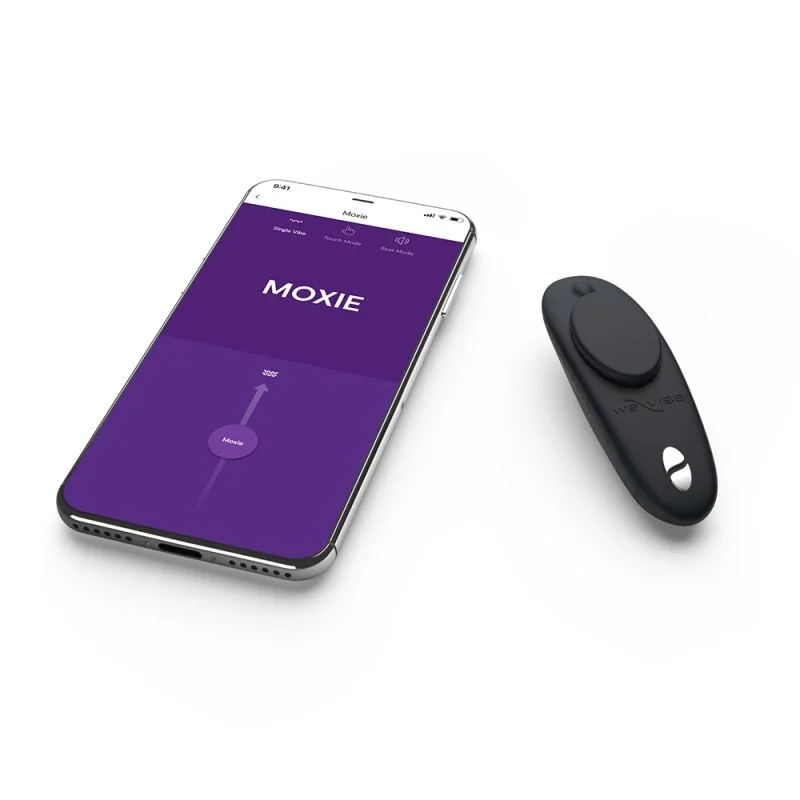 A black We-Vibe Moxie+ app-controlled remote panty vibrator is shown next to a smartphone displaying the Moxie app.