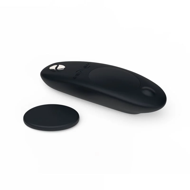 Black app-controlled remote panty vibrator with a separate charging puck.