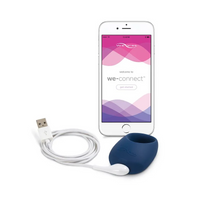 App-controlled vibrating cock ring in midnight blue silicone with charging cable and phone.