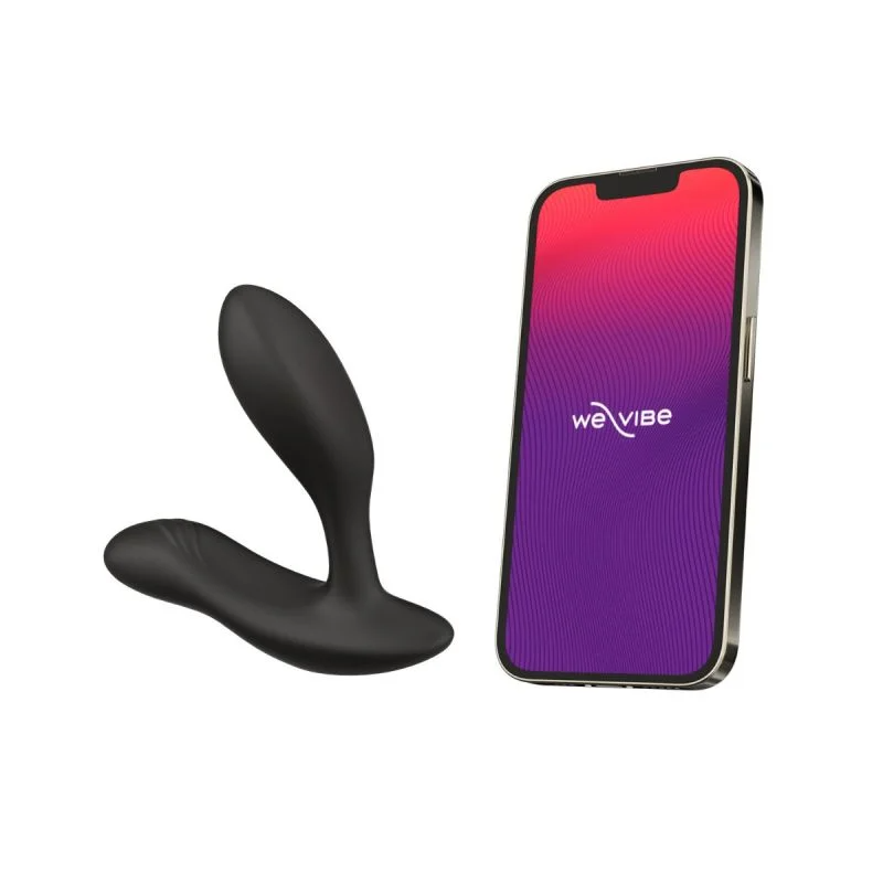 Black dual stimulation vibrator next to a smartphone displaying the We-Vibe logo.