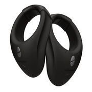 Two black wearable stimulation rings with silver buttons.