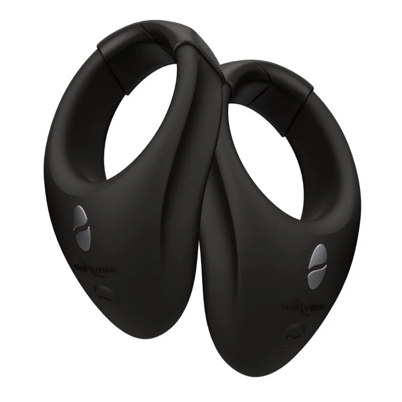 Two black wearable stimulation rings with silver buttons.