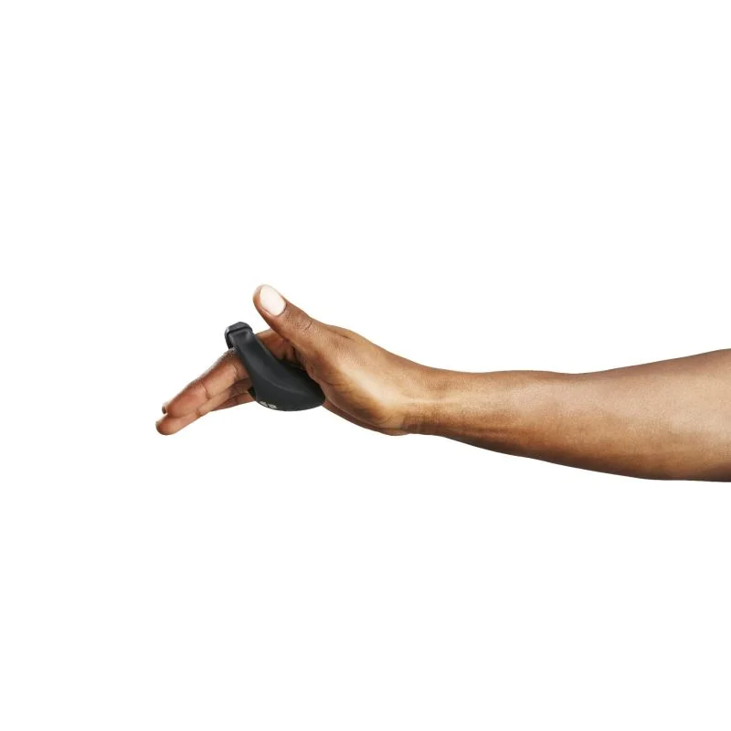 Black wearable stimulation ring on a finger.