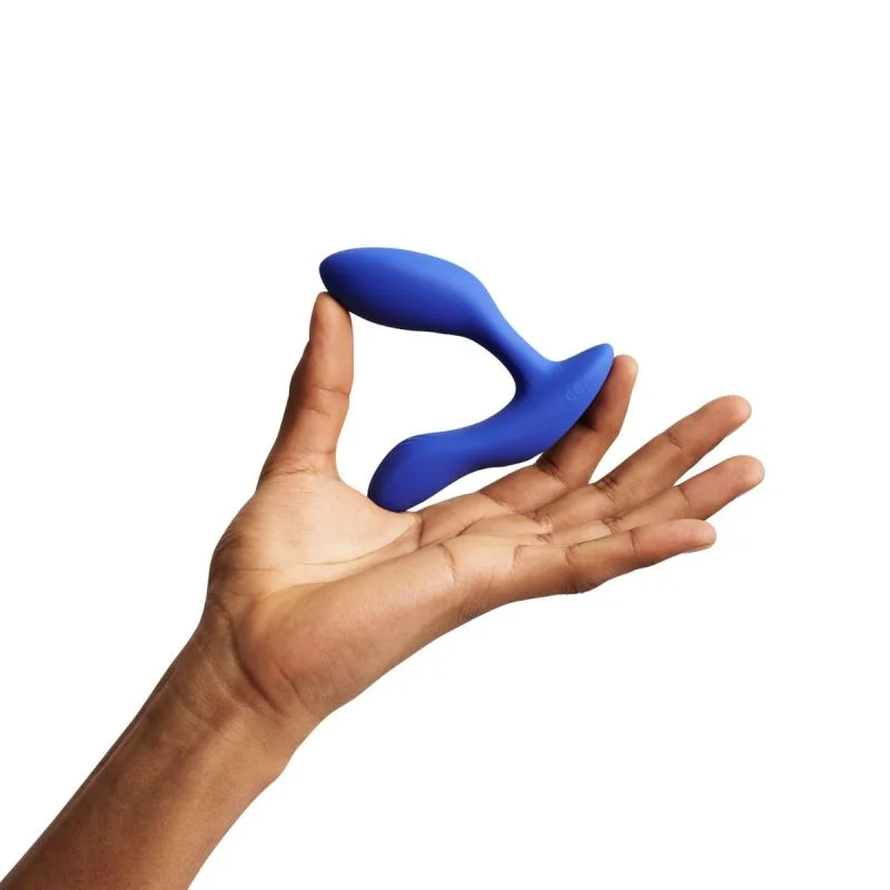 Blue dual prostate and perineum vibrator held in a hand.