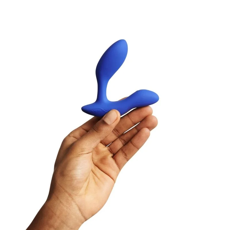 A blue dual prostate and perineum vibrator held in a hand.