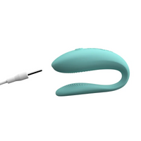 Aqua app-controlled couples vibrator with charging cable.