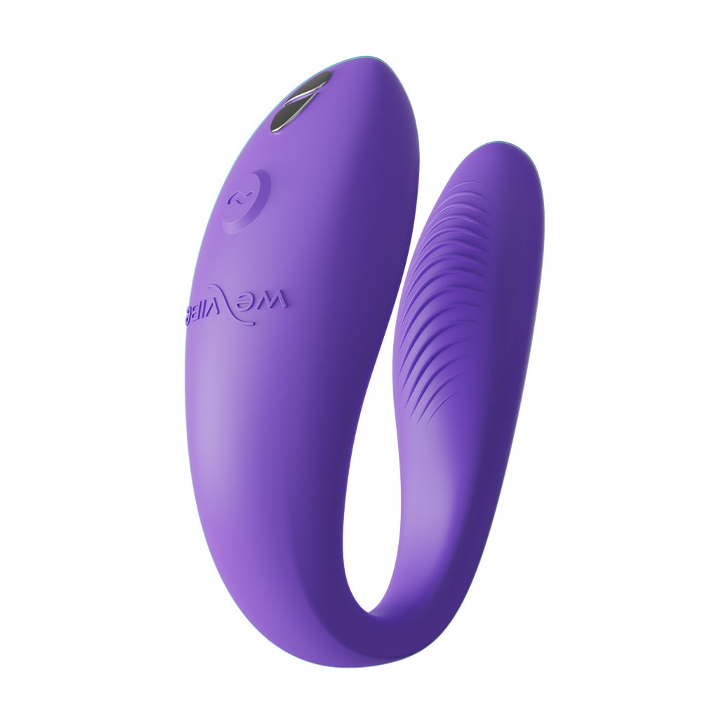 A purple C-shaped vibrator with textured ridges on one arm.