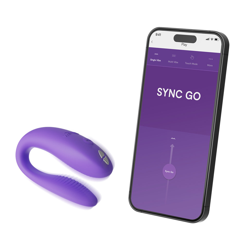 A purple We-Vibe Sync Go couples vibrator next to a smartphone displaying the app.