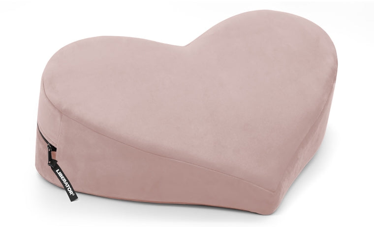 A rose microvelvet heart-shaped wedge pillow with a zipper.