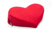 Red heart-shaped microvelvet positioning pillow with a zipper.