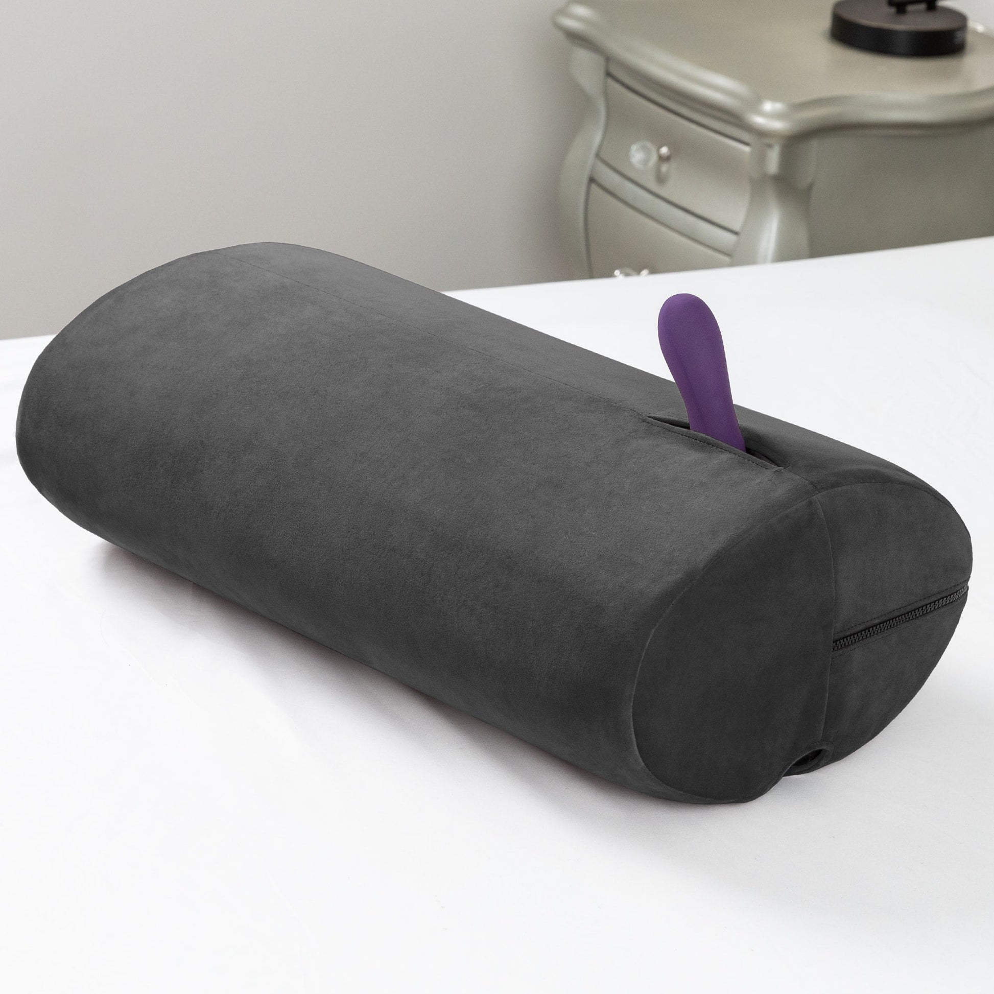 Black microvelvet sex toy mount and positioning pillow with a purple vibrator.