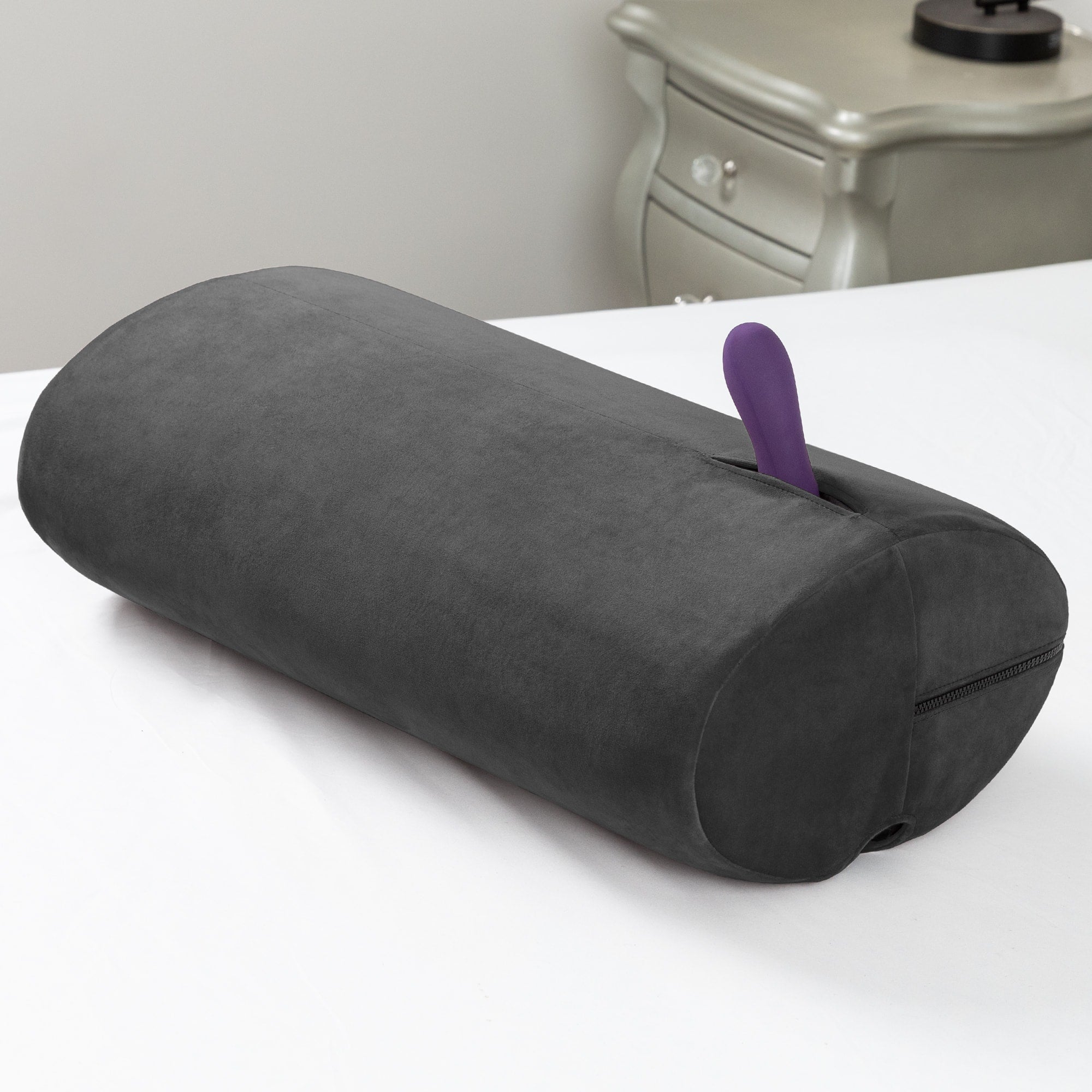 Black microvelvet sex toy mount and positioning pillow with a purple vibrator.