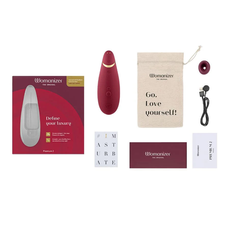Womanizer Premium 2 clitoral vibrator in burgundy with accessories.