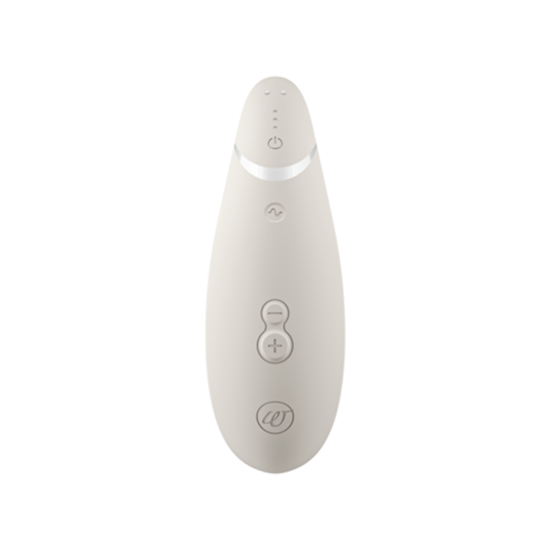 A beige Womanizer Premium 2 clitoral vibrator with buttons and a logo.