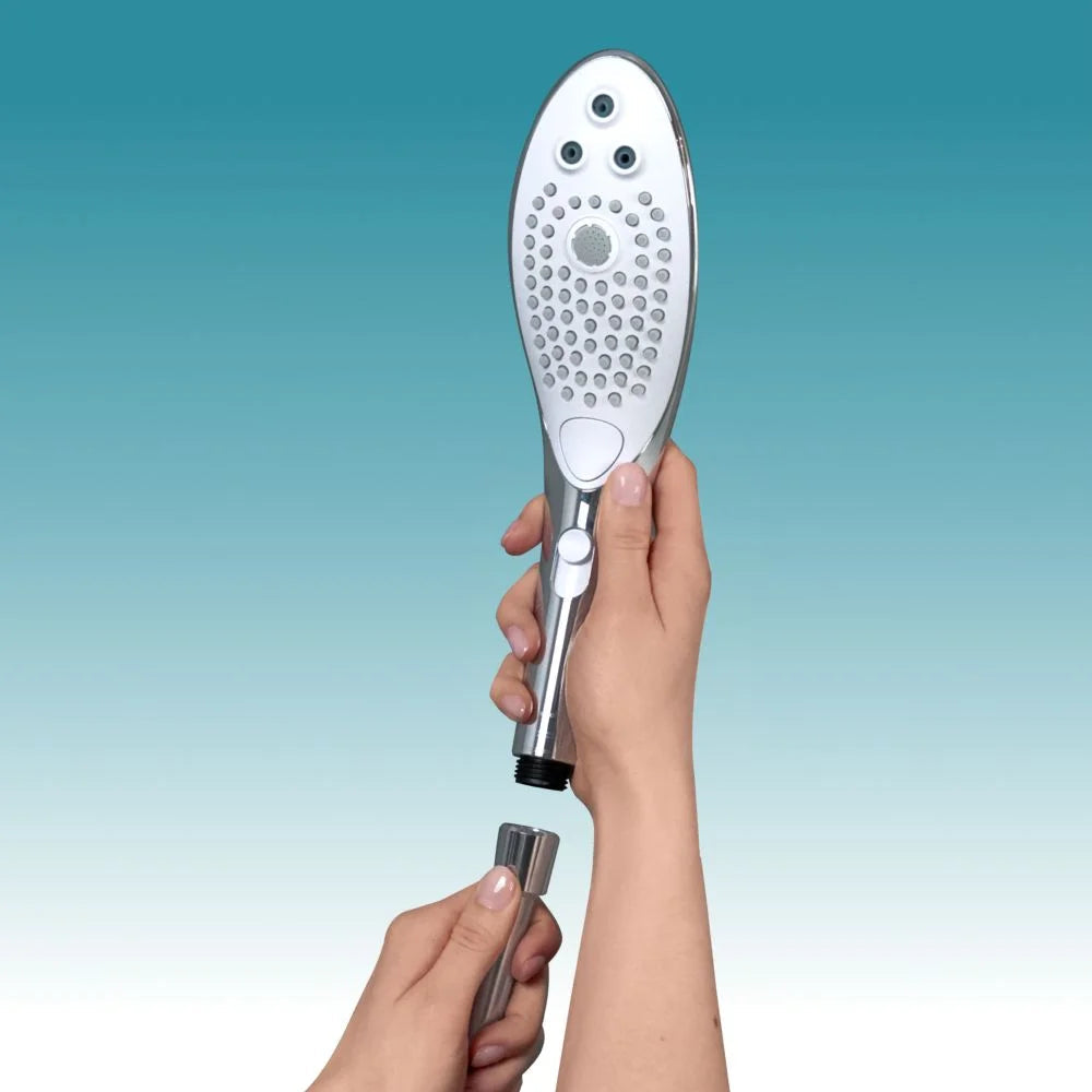 Chrome shower head and hose attachment being held by hands.