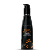 Wicked Sweet Peach flavored water-based intimate lubricant in a black pump bottle.