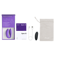 Purple Sync O couples vibrator with charging cable, remote, and storage bag.