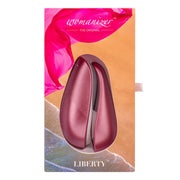Pink rose Womanizer Liberty clitoral stimulator in packaging.