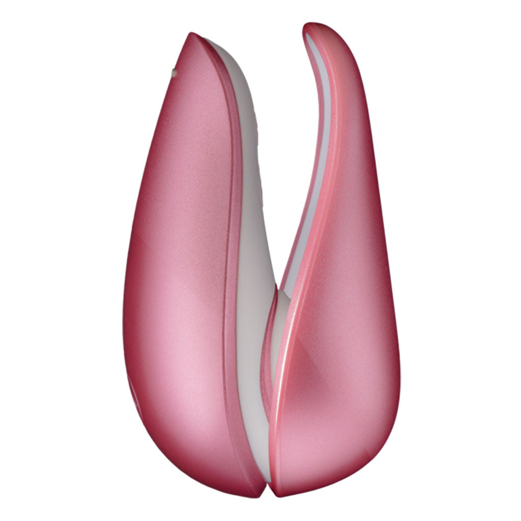 Pink rose clitoral stimulator with a white interior.