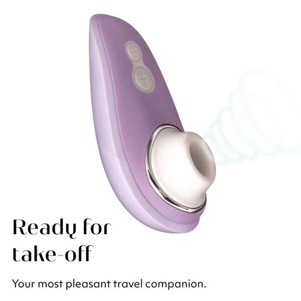 A lilac Womanizer clitoral stimulator with buttons and a white silicone opening.