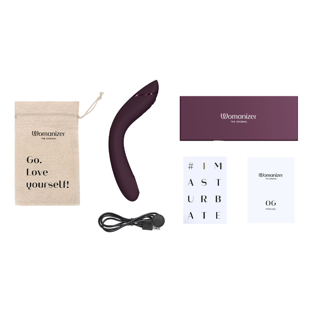 Womanizer OG G-spot vibrator with charging cable, storage bag, and manual.