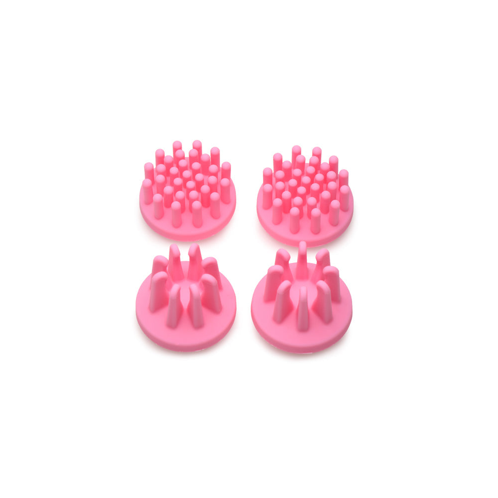 Four pink silicone nipple stimulators with different textured tops.