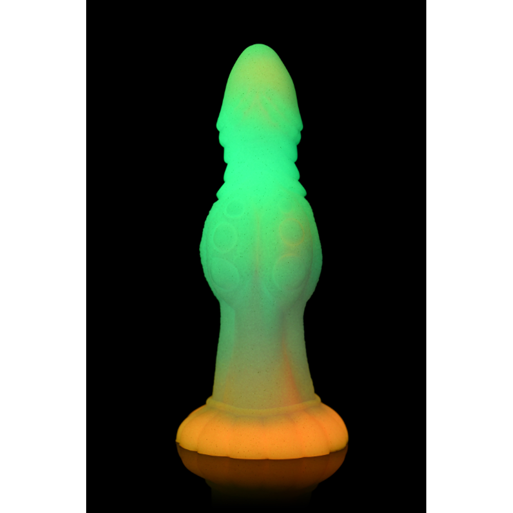 Glow-in-the-dark silicone dildo with a suction cup base and textured surface.