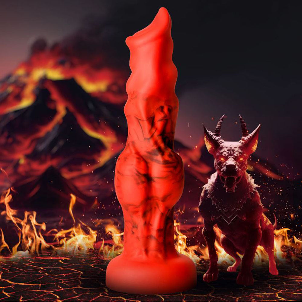 Red silicone dildo with a fantasy design and suction cup base, next to a demonic dog.