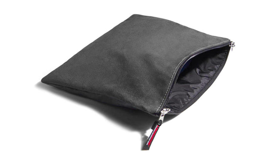 Grey microsuede travel pouch with zipper closure.