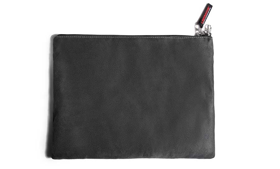 Grey microsuede travel pouch with a red zipper pull.