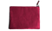 A cherry microsuede toy storage bag with a zipper and a small tag.